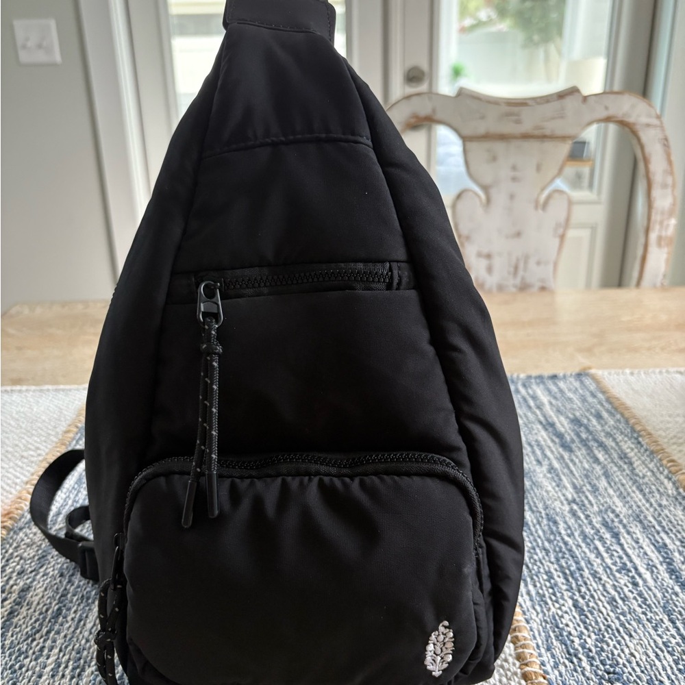 Free People Black Backpack with Adjustable Straps and Sleek Design